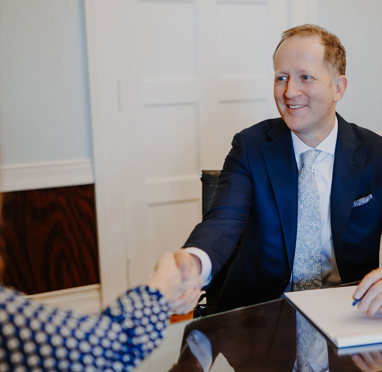 Attorney Dylan Wilbanks shaking hands with client